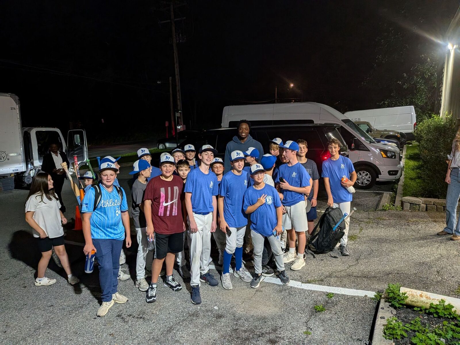 East Coast Athletics players and coaches gathered by the team vans in the evening